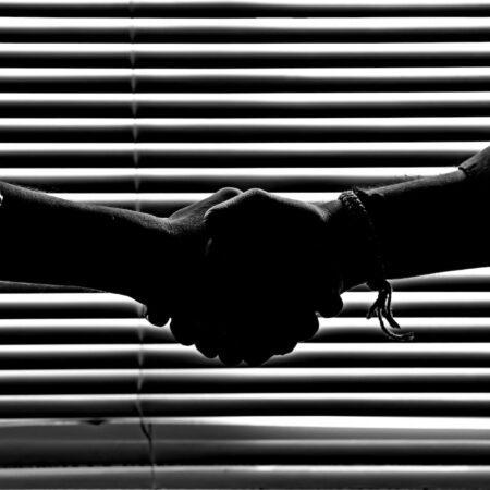 monochrome photography of people shaking hands